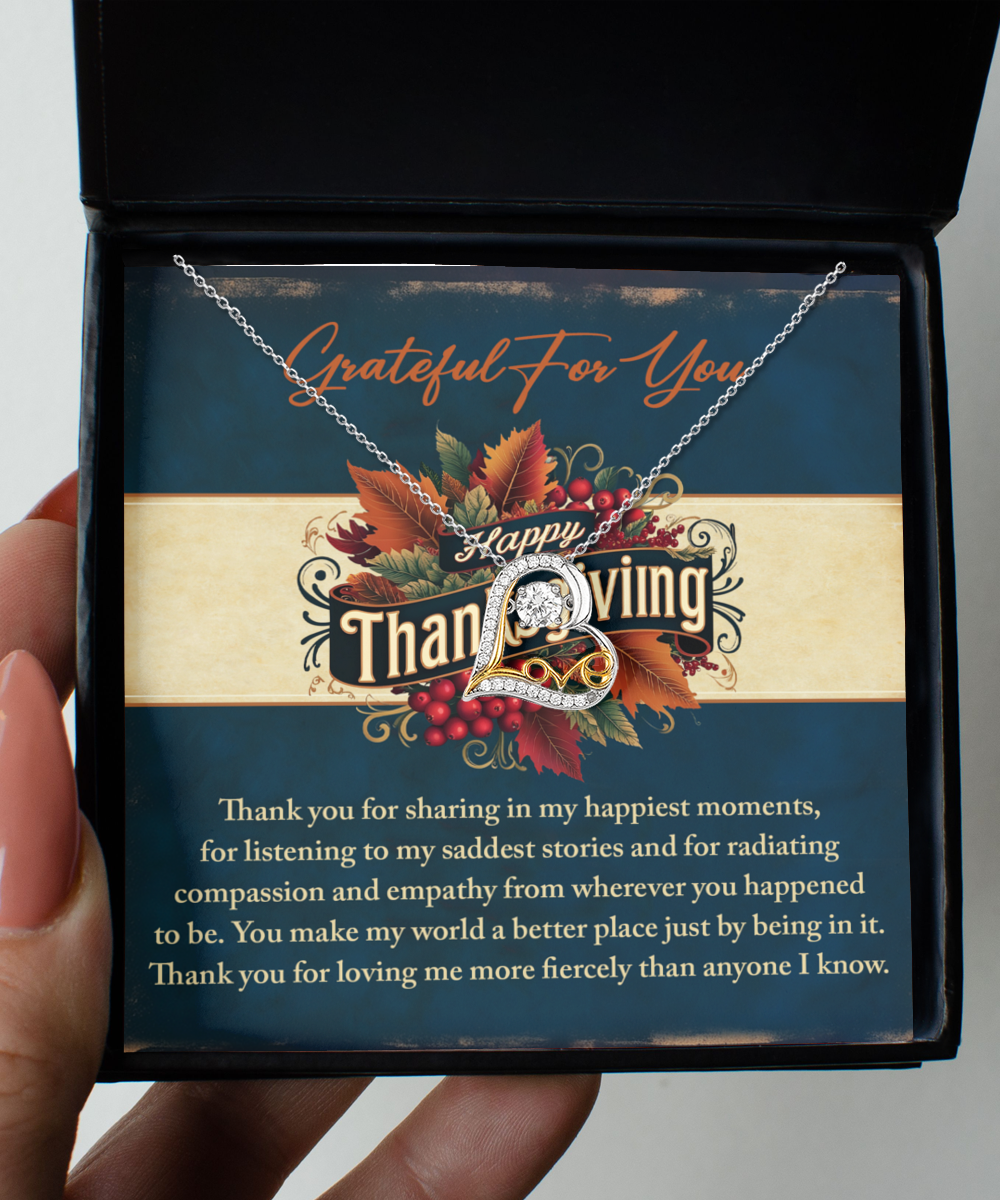 A hand holds an open box containing the Thanksgiving-Happiest Moments - Love Dancing Necklace, featuring a 14k gold pendant and a heartfelt Thanksgiving message.