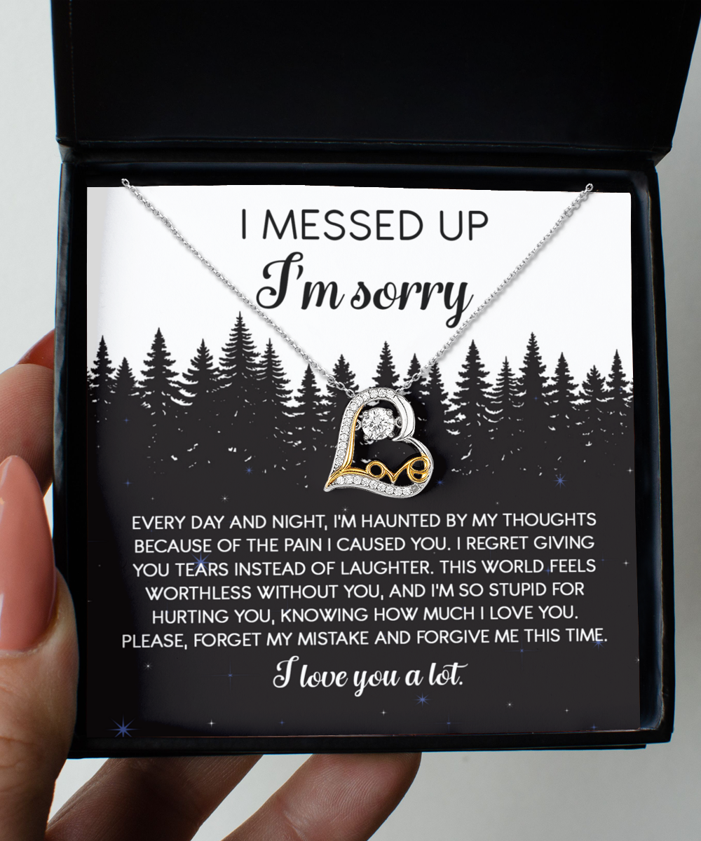 The Sorry-By My Thoughts - Love Dancing Necklace, featuring a heartfelt combination of a silver and gold heart intertwined with an infinity symbol, is elegantly displayed inside a black box. Crafted from 14k gold and sterling silver, this exquisite piece is accompanied by a sincere message expressing an apology and seeking forgiveness.