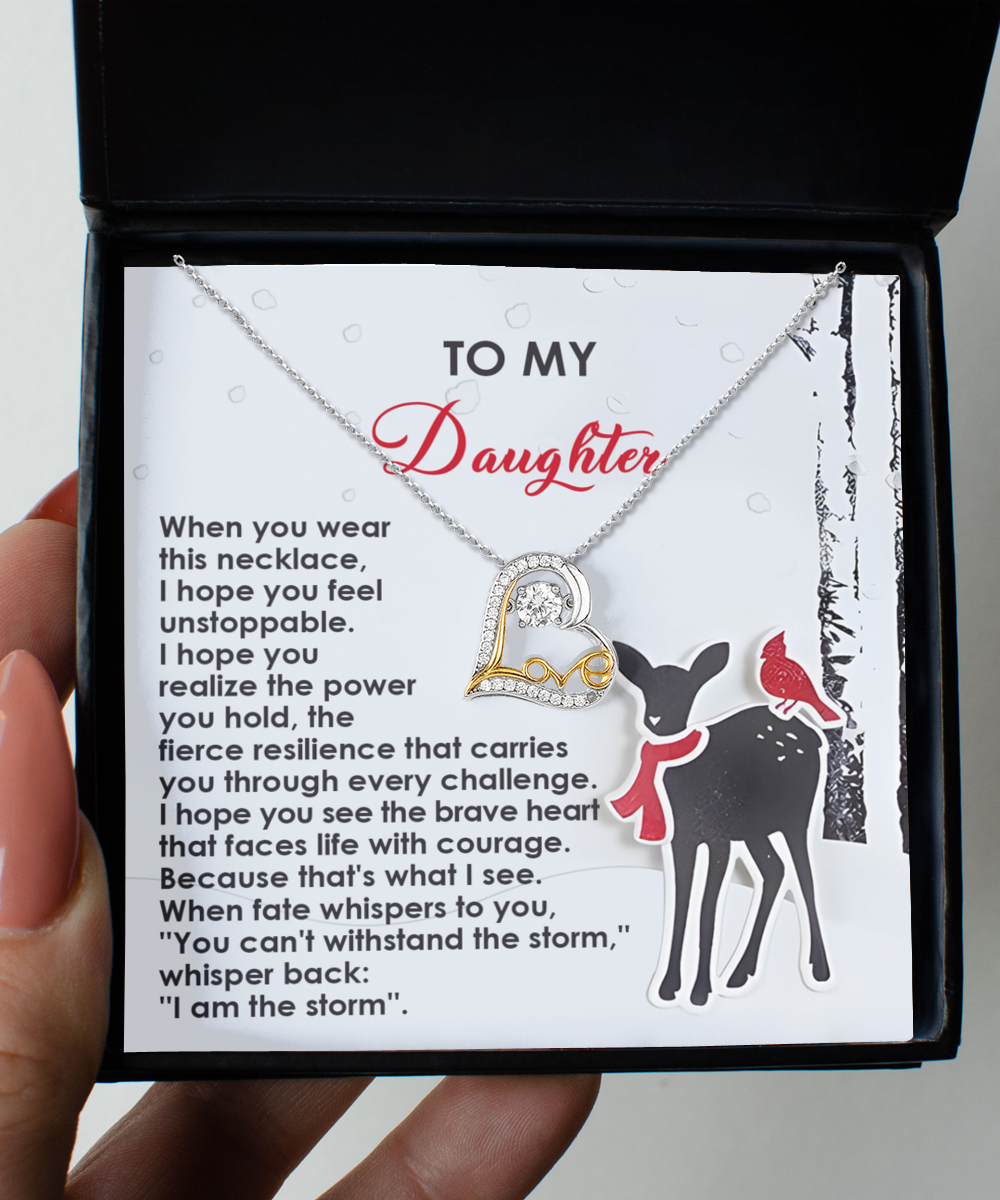 The Daughter-Every Challenge - Love Dancing Necklace, featuring a "love" pendant, is elegantly displayed in a box and comes with a card for your daughter. The card showcases an illustration of a deer and cardinal against a snowy backdrop, beautifully crafted in sterling silver.