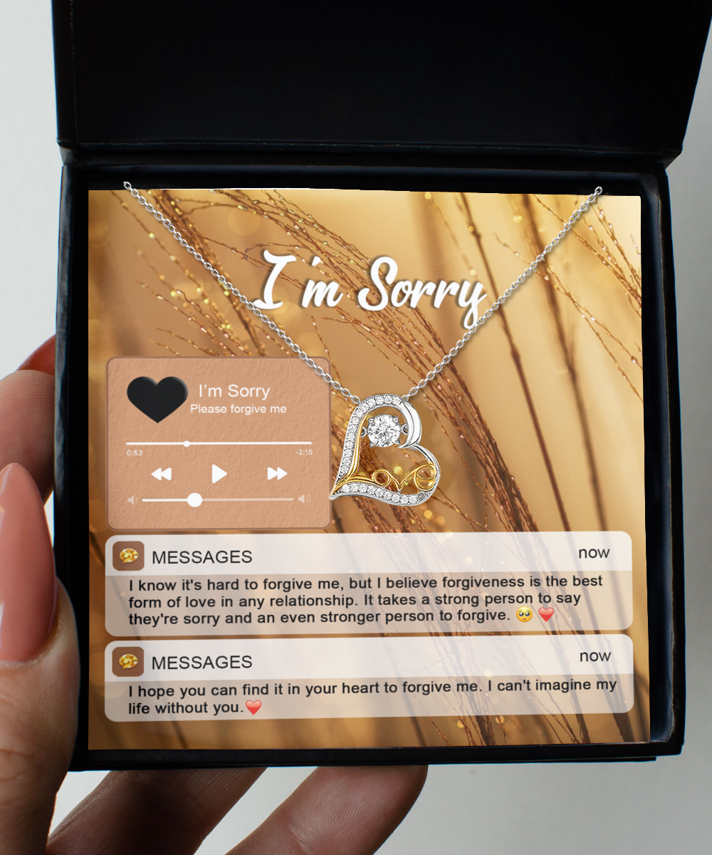 The Sorry-Person To Forgive - Love Dancing Necklace features a heart-shaped pendant crafted from sterling silver with 14k gold accents, presented in a box that reads "I'm Sorry." Included are two text messages expressing apologies and seeking forgiveness, accompanied by an audio player interface displaying "I'm Sorry.