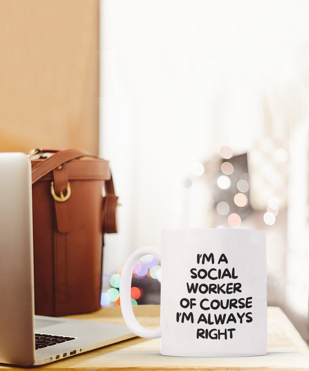 An "I'm a Social Worker of Course I'm Always Right" coffee mug, printed and shipped from the USA, rests beside a laptop and leather bag. This exclusive item is unavailable in stores and offered for a limited time only.