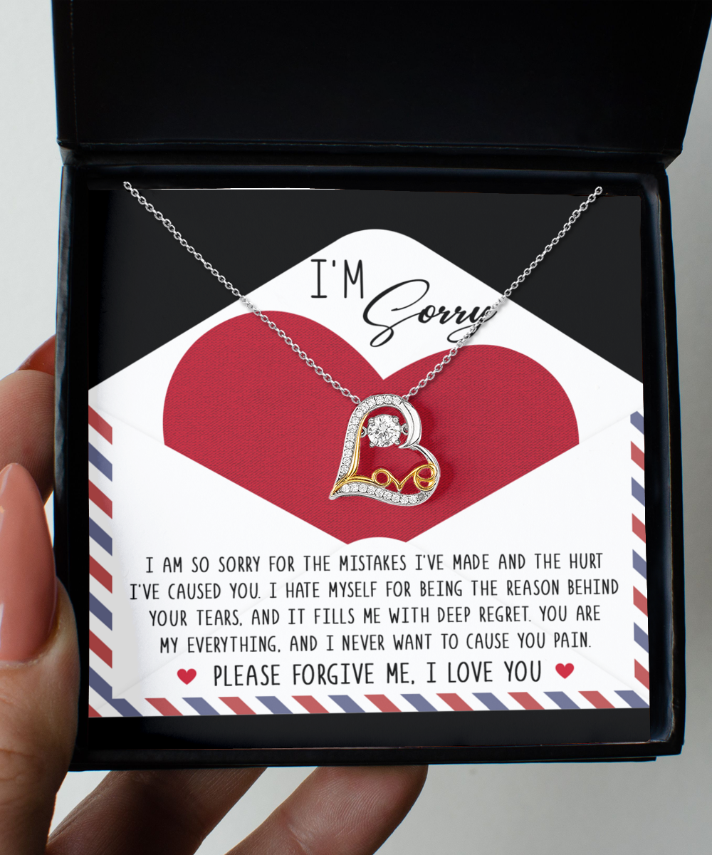 The "Sorry-Behind Your Tears - Love Dancing Necklace," a heart-shaped 14k gold pendant, is presented in a box with an "I'm Sorry" apology note, expressing regret and seeking forgiveness.