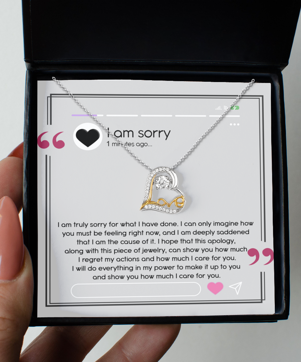 A sterling silver heart-shaped necklace, named the Sorry-Care For You - Love Dancing Necklace, is elegantly showcased in an open box with an apology message inscribed inside. The message conveys profound regret, love, and a promise to make things right.