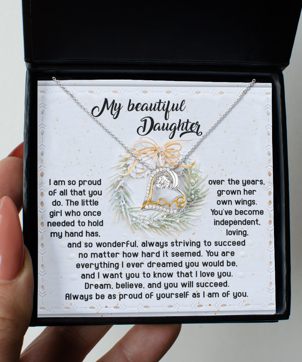 The Daughter-Proud Of Yourself - Love Dancing Necklace arrives in a box with an affectionate message for your daughter, showcasing a decorative letter "L" pendant made of sterling silver.