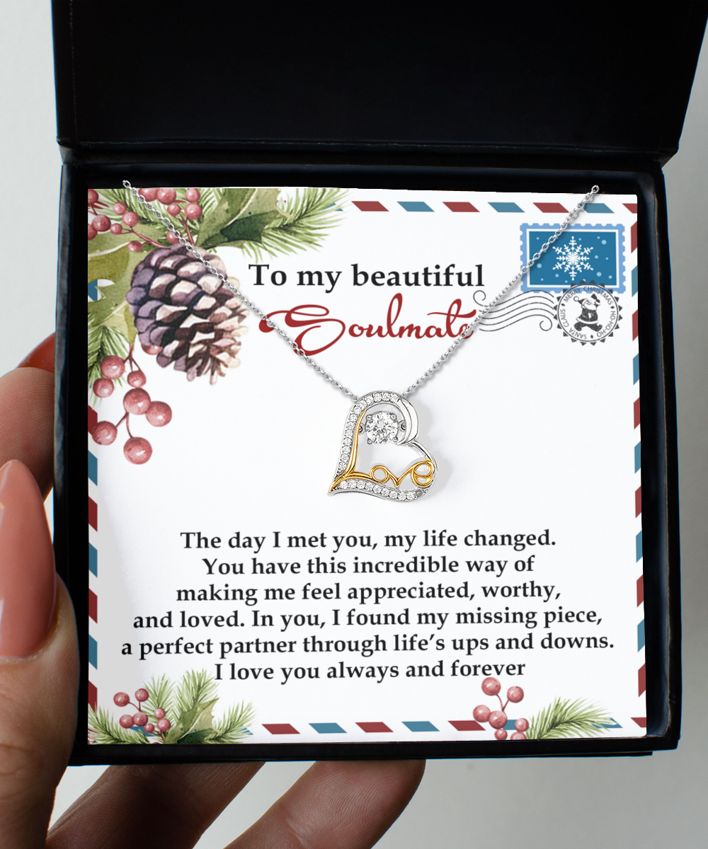 A person holds an open gift box containing a Soulmate-Perfect Partner - Love Dancing Necklace made of shining sterling silver. The box includes a heartfelt card titled "To my beautiful Soulmate," perfectly capturing the moment.