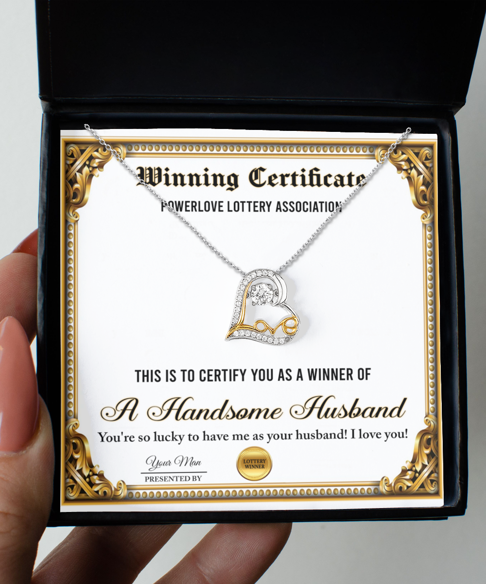 The "To Wife-Winning Certificate - Love Dancing Necklace," featuring a certificate labeled "Winning Certificate" and a heart-shaped sterling silver necklace plated in 14k gold, is presented in a black box. The certificate reads "A Handsome Husband" along with a congratulatory message.