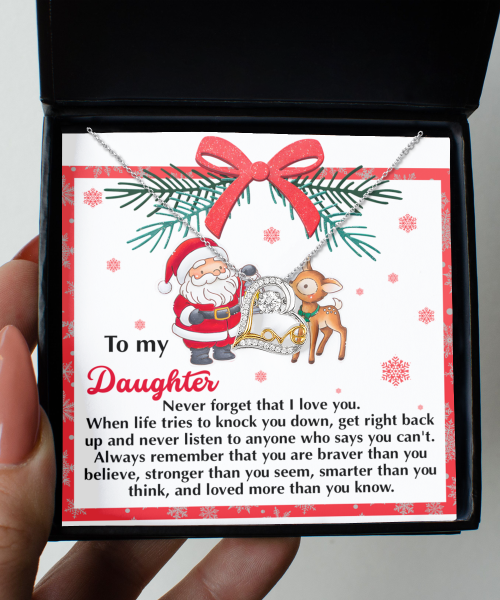 A hand presents an open gift box unveiling the Daughter-Get Back Up - Love Dancing Necklace on a card adorned with Santa and a reindeer, featuring a heartfelt message for a daughter about love and resilience, all beautifully crafted in 14k Gold.