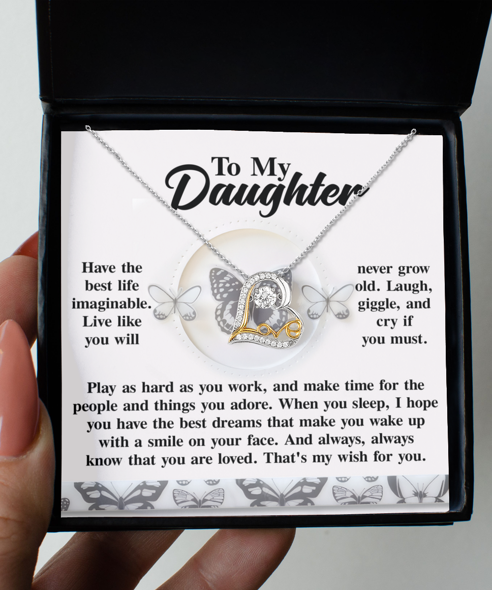 Open the box to reveal the "Daughter-My Wish" Love Dancing Necklace, showcasing a letter "L" pendant in elegant sterling silver. The accompanying message provides life advice, encouraging happiness, resilience, and love. The card is beautifully adorned with butterflies.