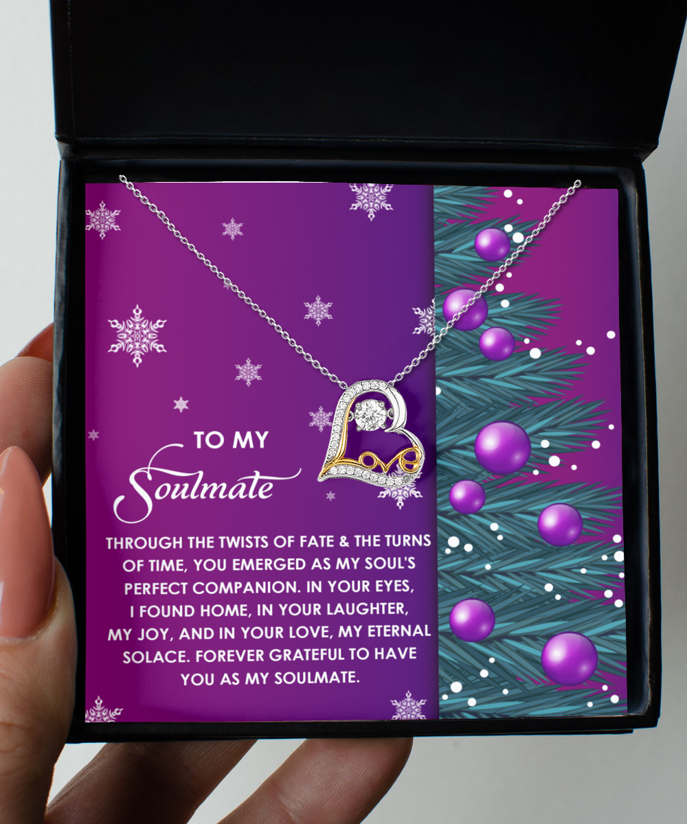 Introducing the Soulmate-Perfect Companion - Love Dancing Necklace: a heart-shaped gem exquisitely designed in sparkling sterling silver with a circular pendant. It comes elegantly packaged in a box adorned with a purple background, text, and intricate snowflake and branch motifs.