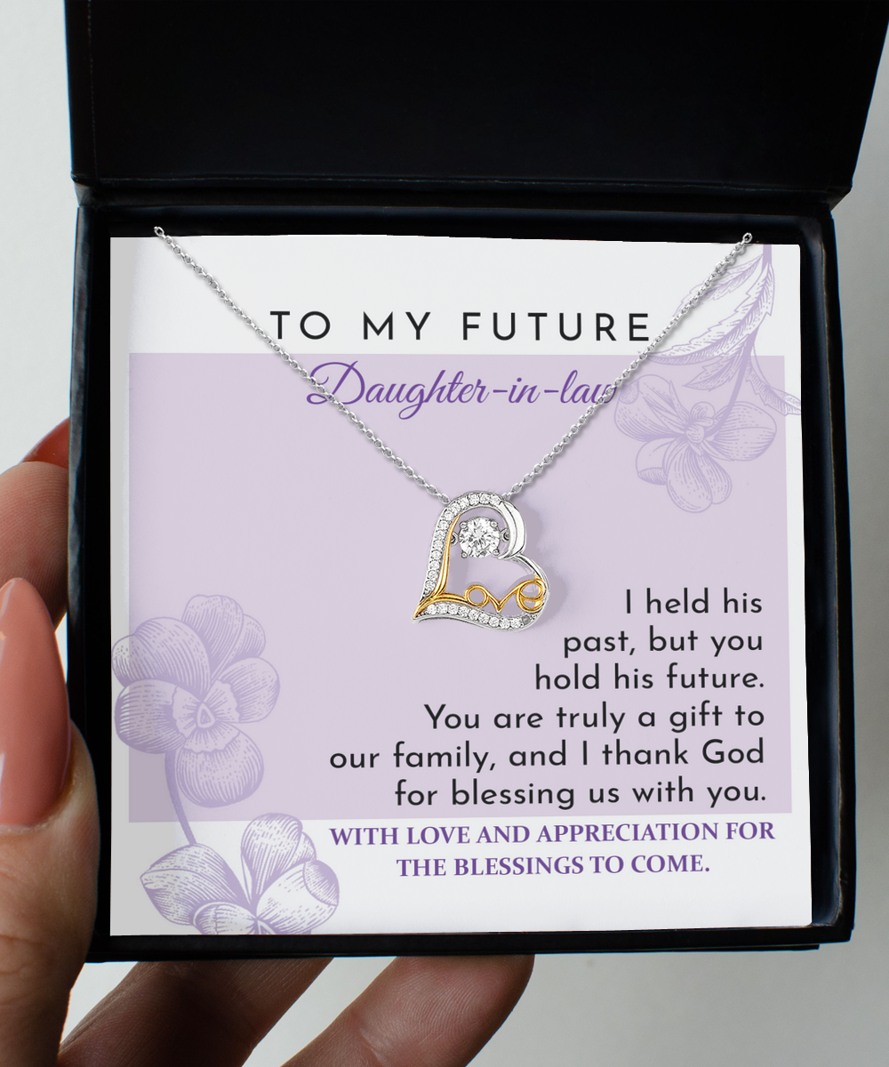 A "To Daughter-in-law, A Gift - Love Dancing Necklace" lies on top of a card in a black box. The card has a message expressing love and appreciation for a future daughter-in-law.