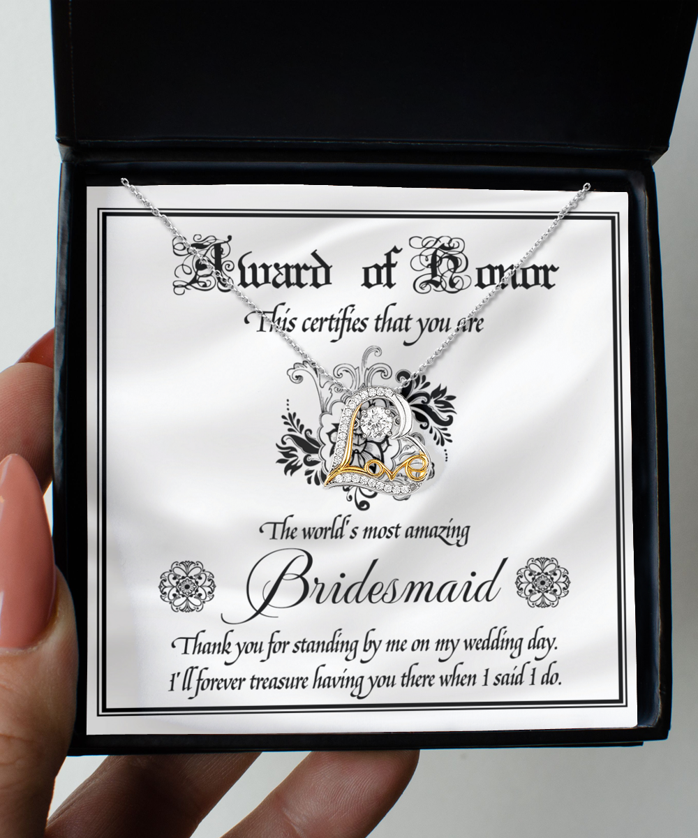 A decorative card inside a black box features a stunning 14k gold Love Dancing Necklace. The text reads: "Award of Honor. This certifies that you are the world's most amazing Bridesmaid. Thank you for standing by me on my wedding day." The product is named "To Bridesmaid-Award Of Honor - Love Dancing Necklace.