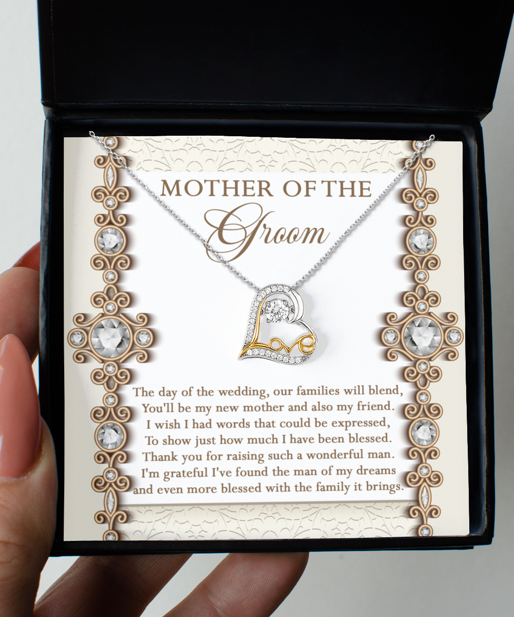 A Mom Of Groom-New Mother - Love Dancing Necklace with a sterling silver chain and a pendant is displayed on a decorative card inside an open black box. The card reads "Mother of the Groom" and includes an emotional message expressing gratitude.