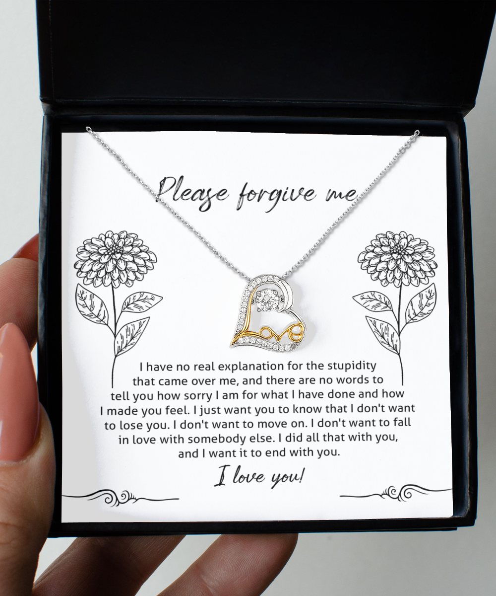 The Sorry-Real Explanation - Love Dancing Necklace, crafted from sterling silver with a heart-shaped pendant, is placed inside a box. The inner lid of the box features an apology message surrounded by flower illustrations.