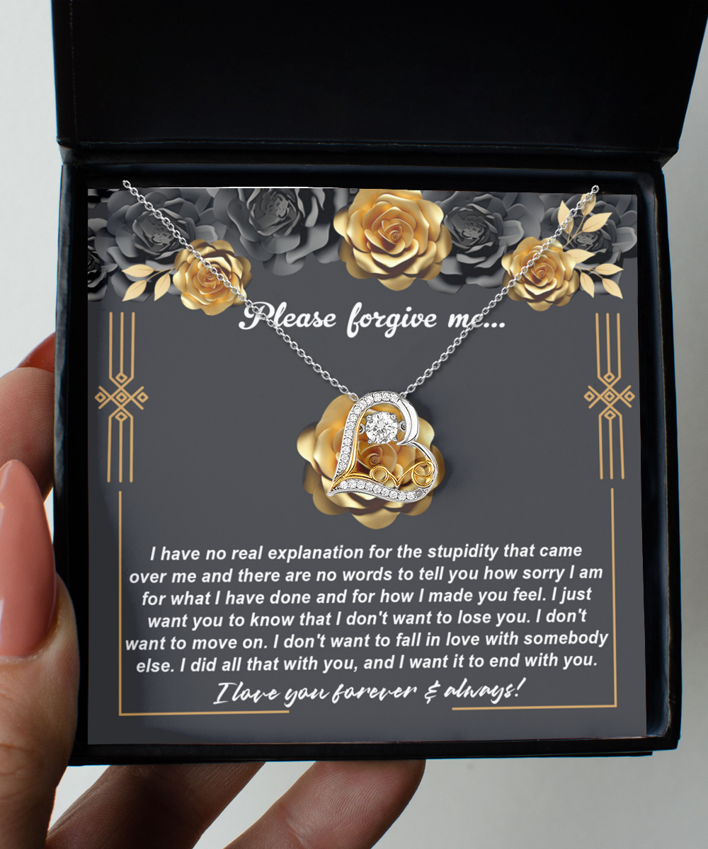 The "Sorry-End With You - Love Dancing Necklace," featuring a heart-shaped pendant, is elegantly displayed in a box. Inside the box, a note reads "Please forgive me" along with a heartfelt apology. The background is adorned with roses and gray floral decorations, adding an elegant touch.