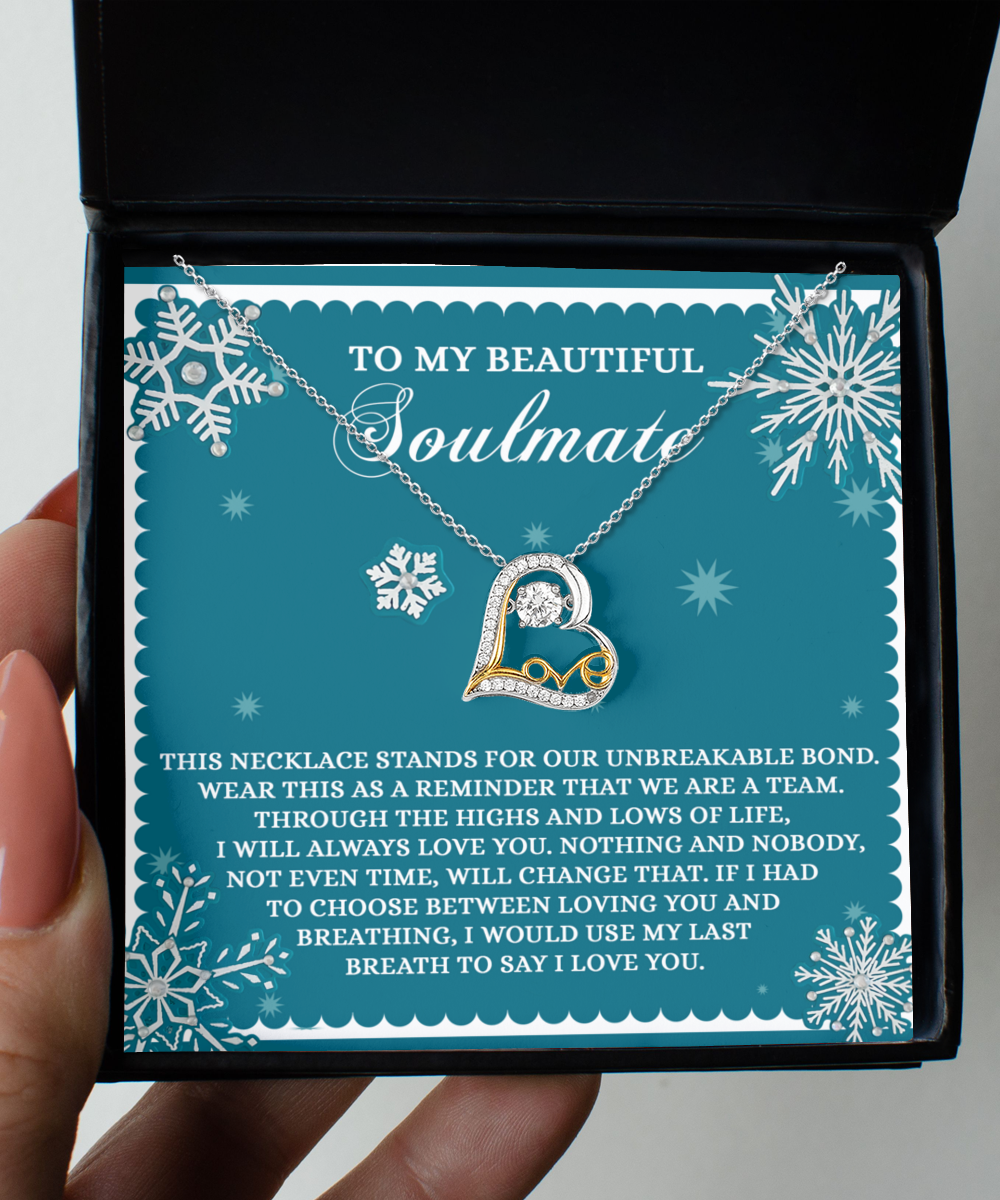 A hand holds an open box featuring the Soulmate-A Team - Love Dancing Necklace with a heart pendant on a card that reads: "To my beautiful soulmate," followed by a sentimental message.