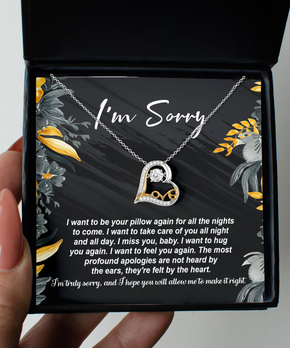 The Sorry-Be Your Pillow - Love Dancing Necklace features a 14k gold necklace with a heart-shaped pendant, elegantly presented in a box alongside an apology note that reads "I'm Sorry," accompanied by a heartfelt message expressing how much you miss and want to comfort the recipient. This exquisite piece beautifully combines elegance and sentiment.