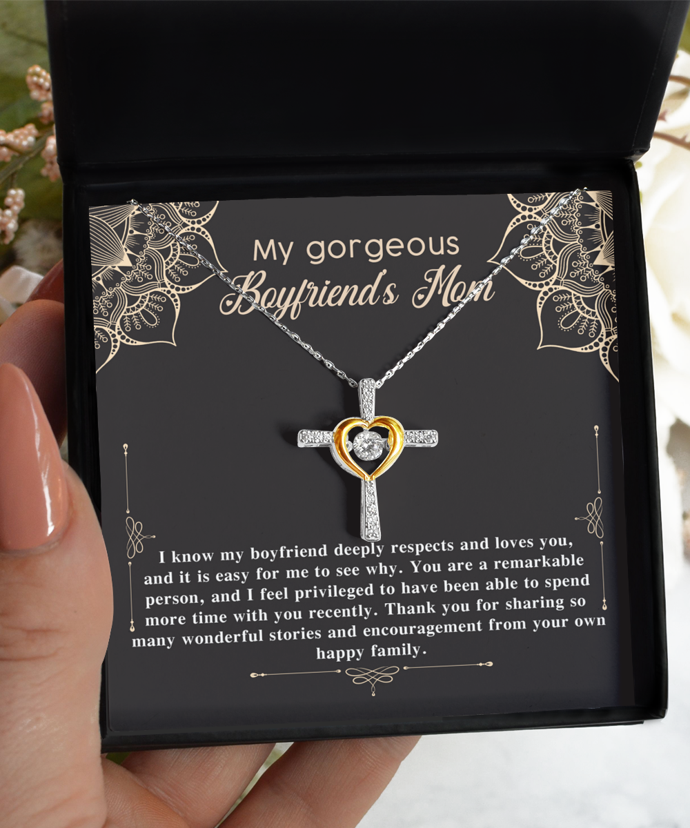 A hand holding an open jewelry box with a Gearbubble 14k gold plated To Boyfriend's Mom, Happy Family - Cross Dancing Necklace and a message for a boyfriend's mother.