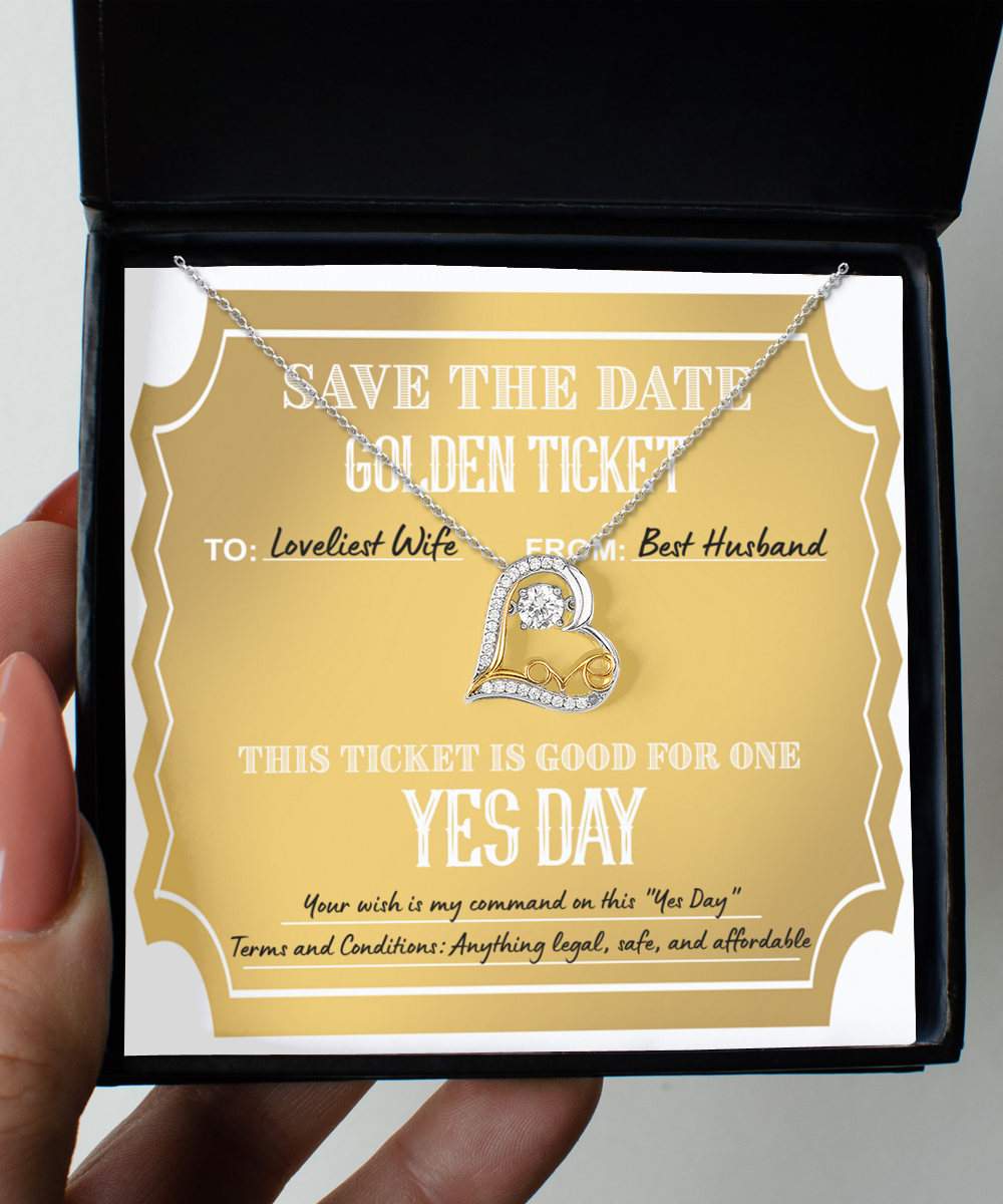 A "To Wife-Golden Ticket - Love Dancing Necklace" in a gift box on top of a golden ticket reading: "Save the Date. Golden Ticket. To: Loveliest Wife, From: Best Husband. This 14k gold plated ticket is good for one Yes Day.