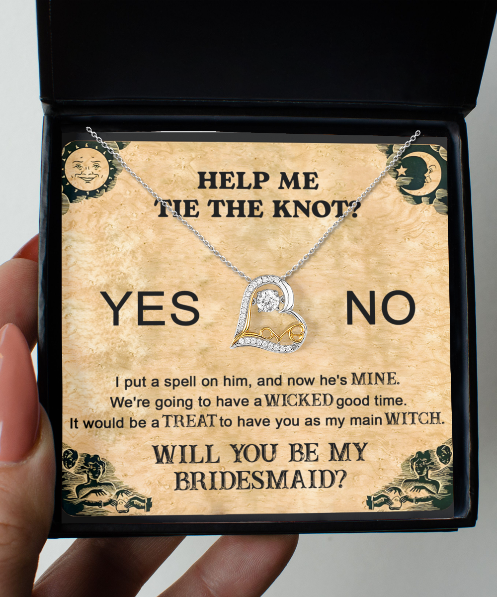 A Bridesmaid-My Main Witch - Love Dancing Necklace nestled inside a box adorned with the words, "HELP ME TIE THE KNOT? YES NO WILL YOU BE MY BRIDESMAID?" and text themed around witches and spells.