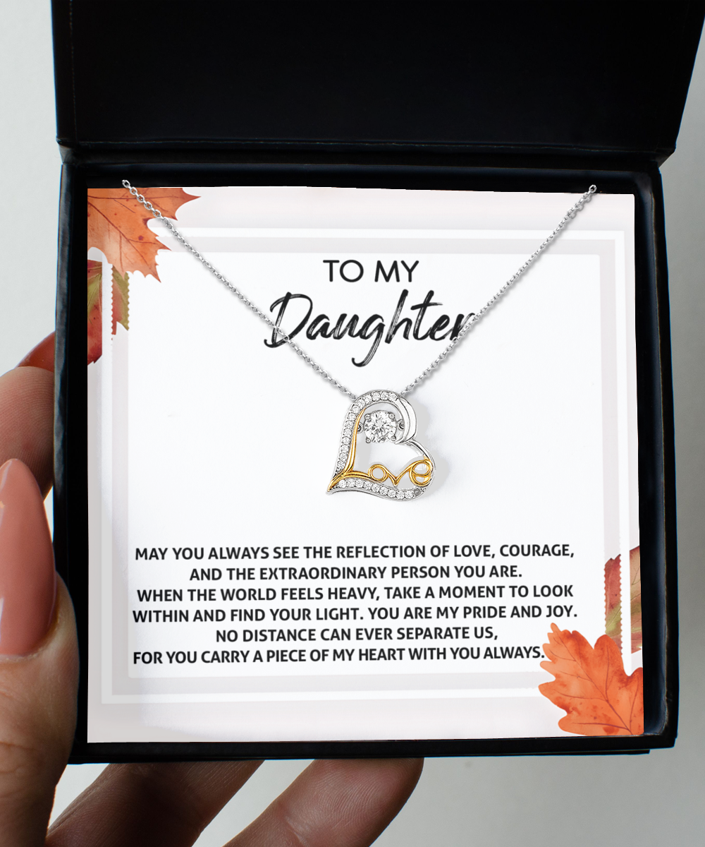 The Daughter-Find Your Light - Love Dancing Necklace, crafted in a heart-shaped Sterling Silver design and inscribed with "Love", comes elegantly presented in a box along with a heartfelt message for a daughter about love, courage, and connection.