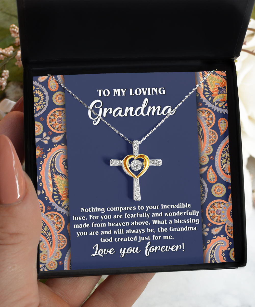 A hand presenting a personalized jewelry gift box with a To Grandma, Just For Me - Cross Dancing Necklace from Gearbubble and a heartfelt message for a grandmother.