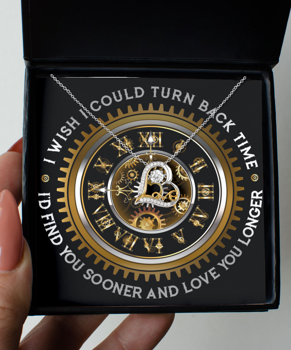 The "To Wife-Turn Back Time- Love Dancing Necklace" features a heart-shaped pendant crafted from sterling silver and adorned with a clockwork design. This elegant necklace comes in a black box, surrounded by Roman numerals and gears, and bears the poignant inscription: "I wish I could turn back time. I'd find you sooner and love you longer.