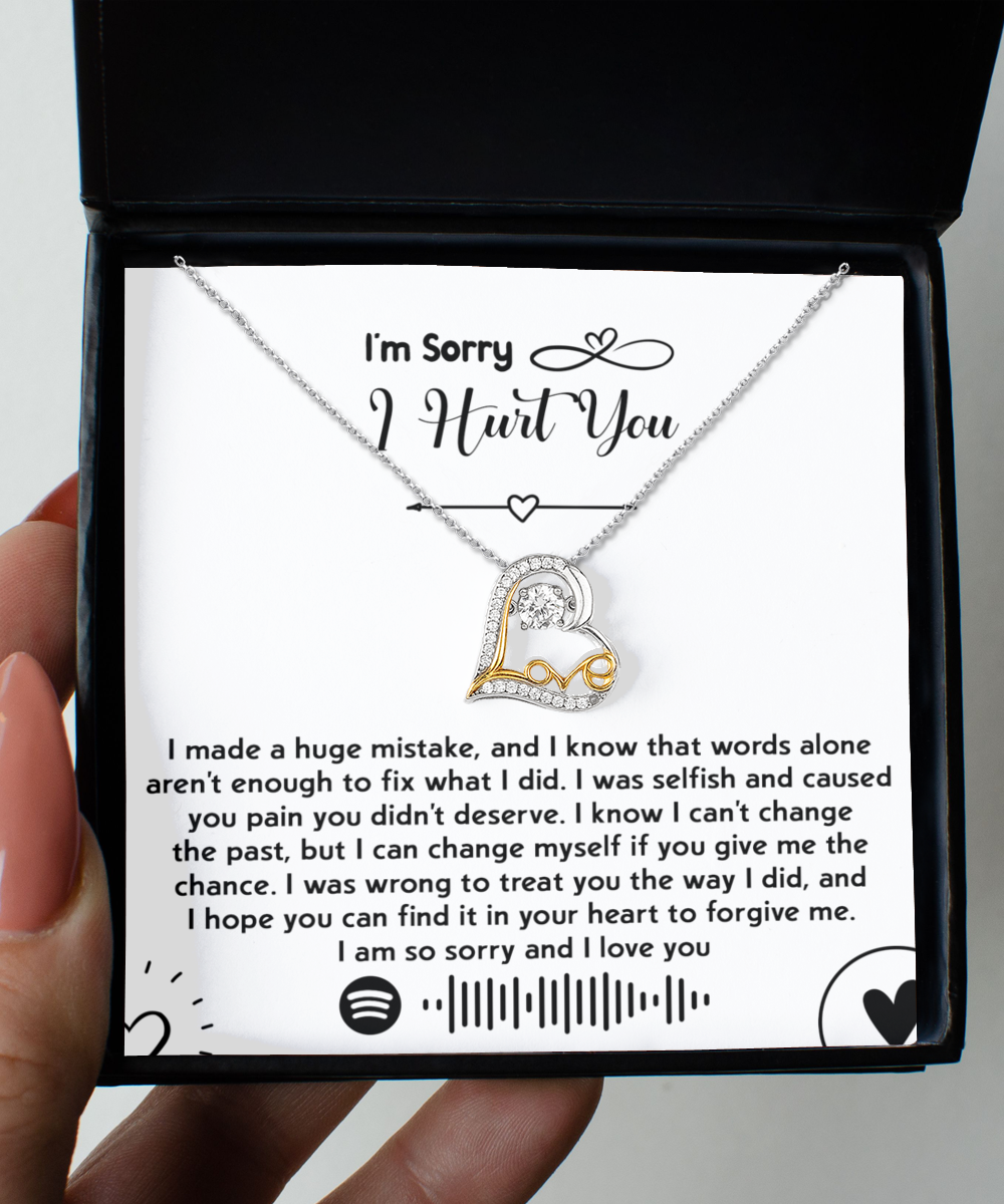 Introducing the "Sorry-You Didn't Deserve - Love Dancing Necklace," featuring a 14k gold heart-shaped pendant nestled neatly inside a box. Accompanying the necklace is an apology note expressing sincere regret and seeking forgiveness, along with a Spotify code.