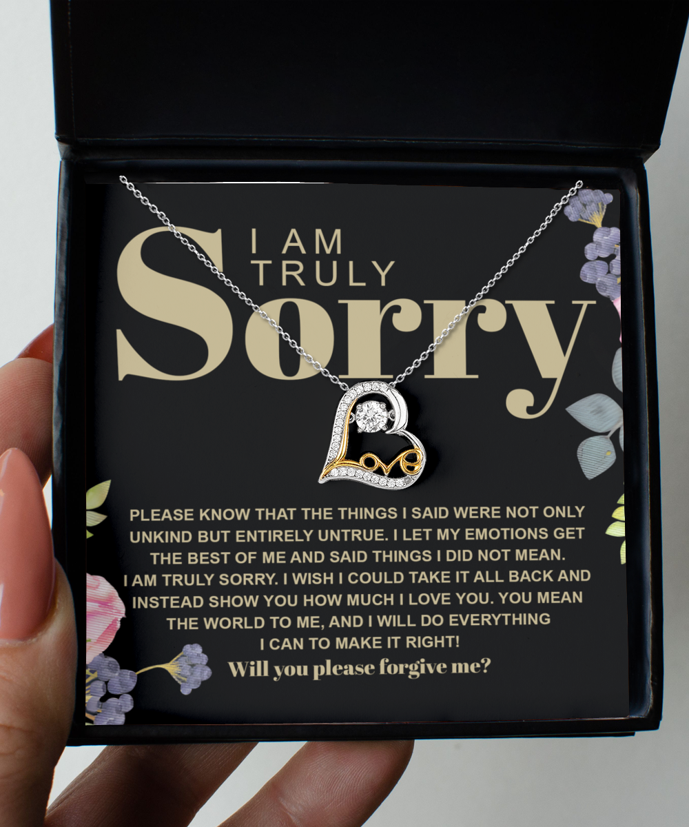 The Sorry-Best Of Me - Love Dancing Necklace, made of .925 Sterling Silver with a heart pendant, is showcased in an open black box. The lid is adorned with an apology message in both large and small fonts, accompanied by delicate floral elements. This necklace exudes elegance and heartfelt sentiment, making it the perfect choice for making amends.