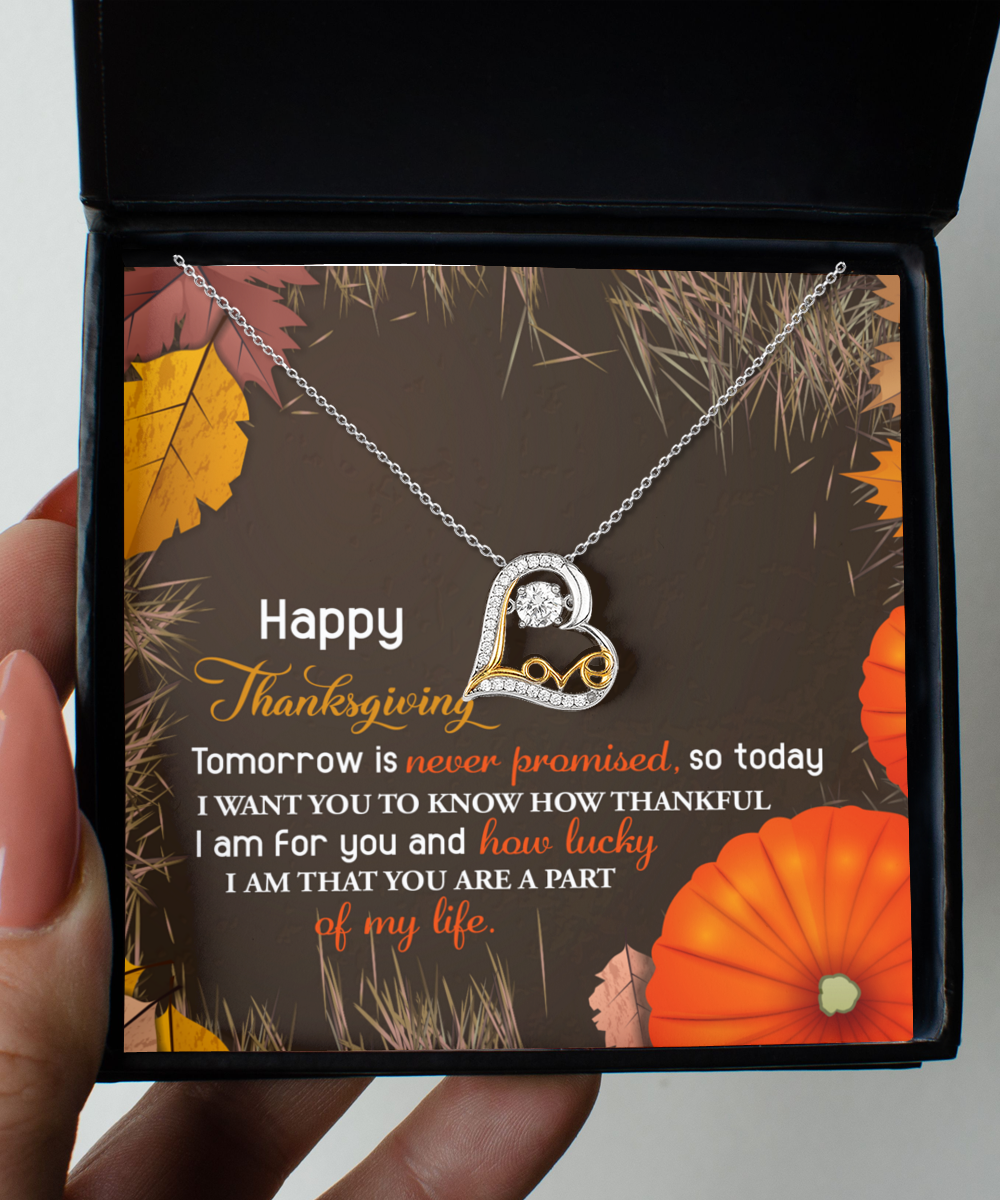 The Thanksgiving-How Lucky - Love Dancing Necklace, beautifully enclosed in a box with a heartfelt Thanksgiving message, is gracefully surrounded by autumn leaves and pumpkins, bringing an elegant touch to your holiday celebration.