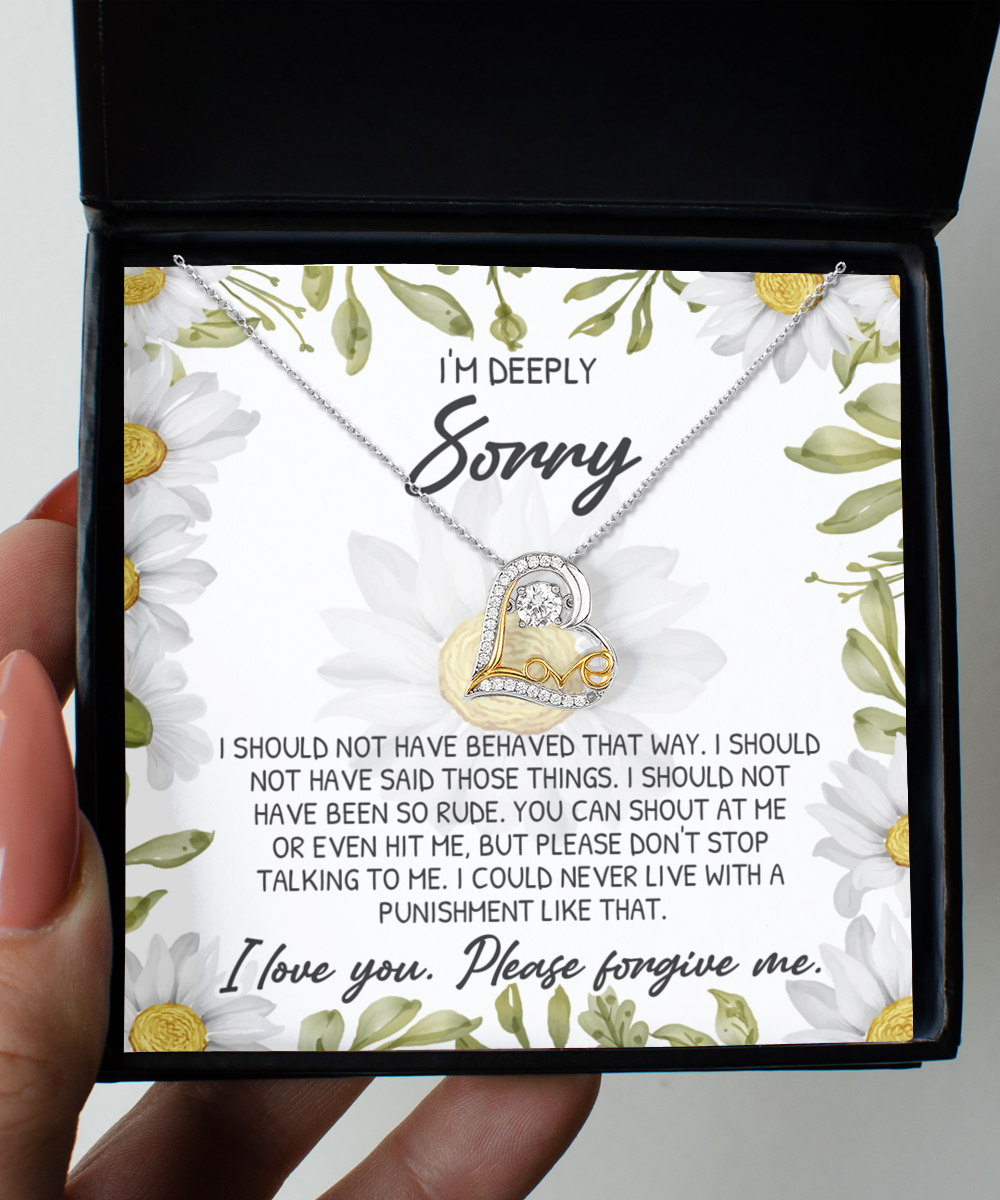 A hand holds an open box containing a "Sorry-Please Don’t Top - Love Dancing Necklace" and a lettered apology inside. The letter expresses regret for rude behavior and pleads for forgiveness. The necklace, made of .925 Sterling Silver, features a heart and key design, symbolizing the sincerity of the heartfelt apology.