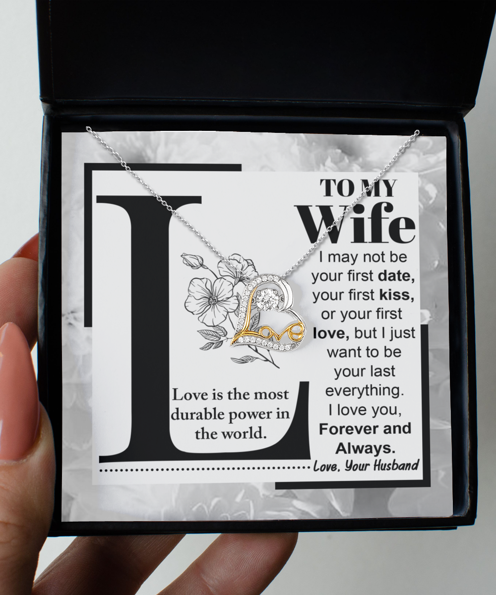 A "To Wife, Love Is - Love Dancing Necklace" is displayed, accompanied by a card that reads: "To My Wife: Love is the most durable power in the world. I love you, Forever and Always. Love, Your Husband.