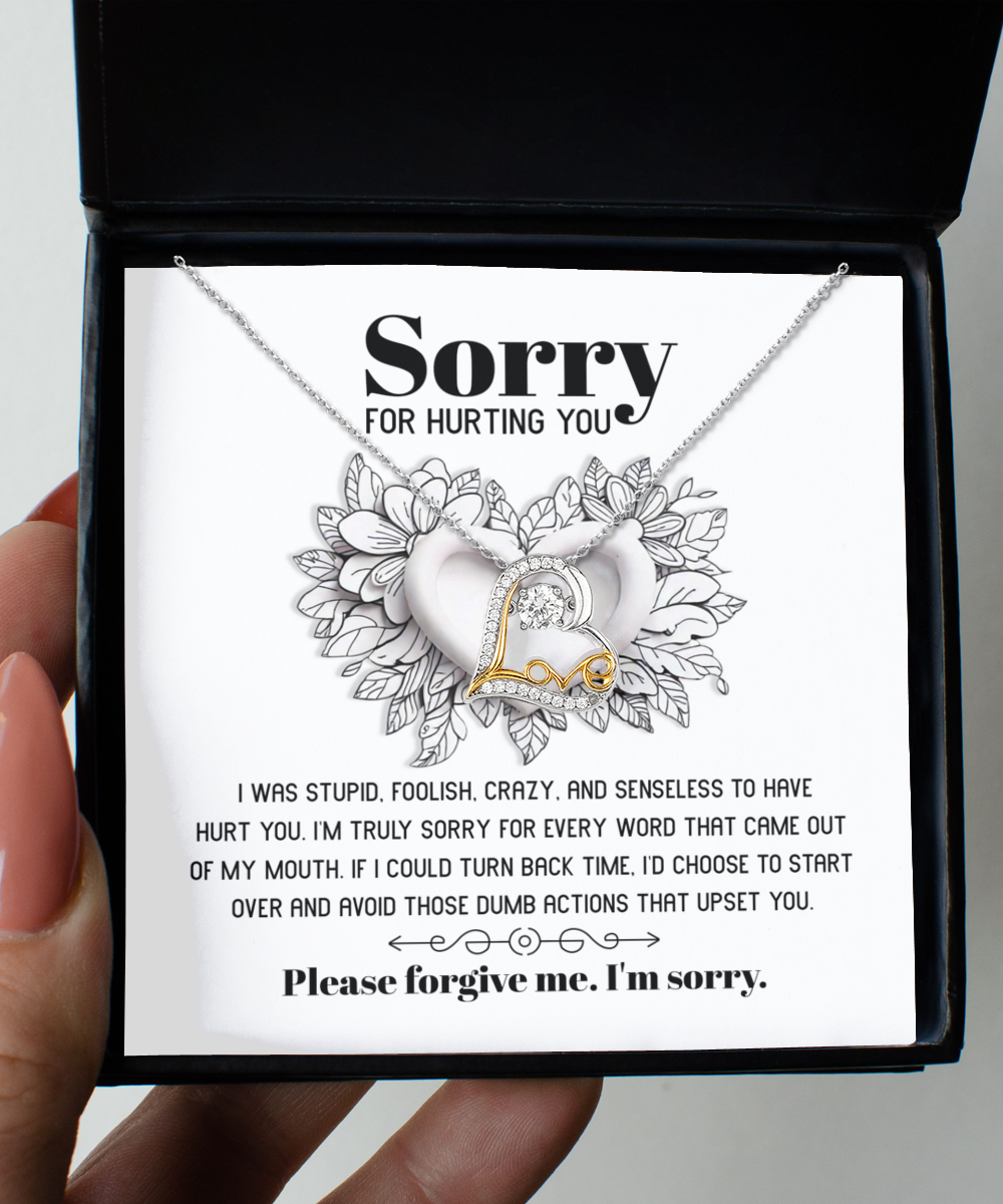 A stunning heart-shaped necklace, the Sorry-Turn Back Time - Love Dancing Necklace, featuring 14k gold plating and accompanied by a heartfelt note expressing an apology for past actions and a plea for forgiveness.