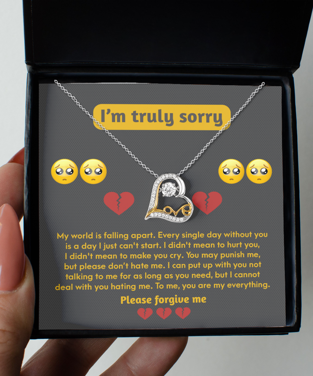 A sterling silver "Sorry-Make You Cry - Love Dancing Necklace" with a heart-shaped pendant rests in a black box. The box contains an apology message expressing regret and asking for forgiveness, decorated with crying and heart emojis.