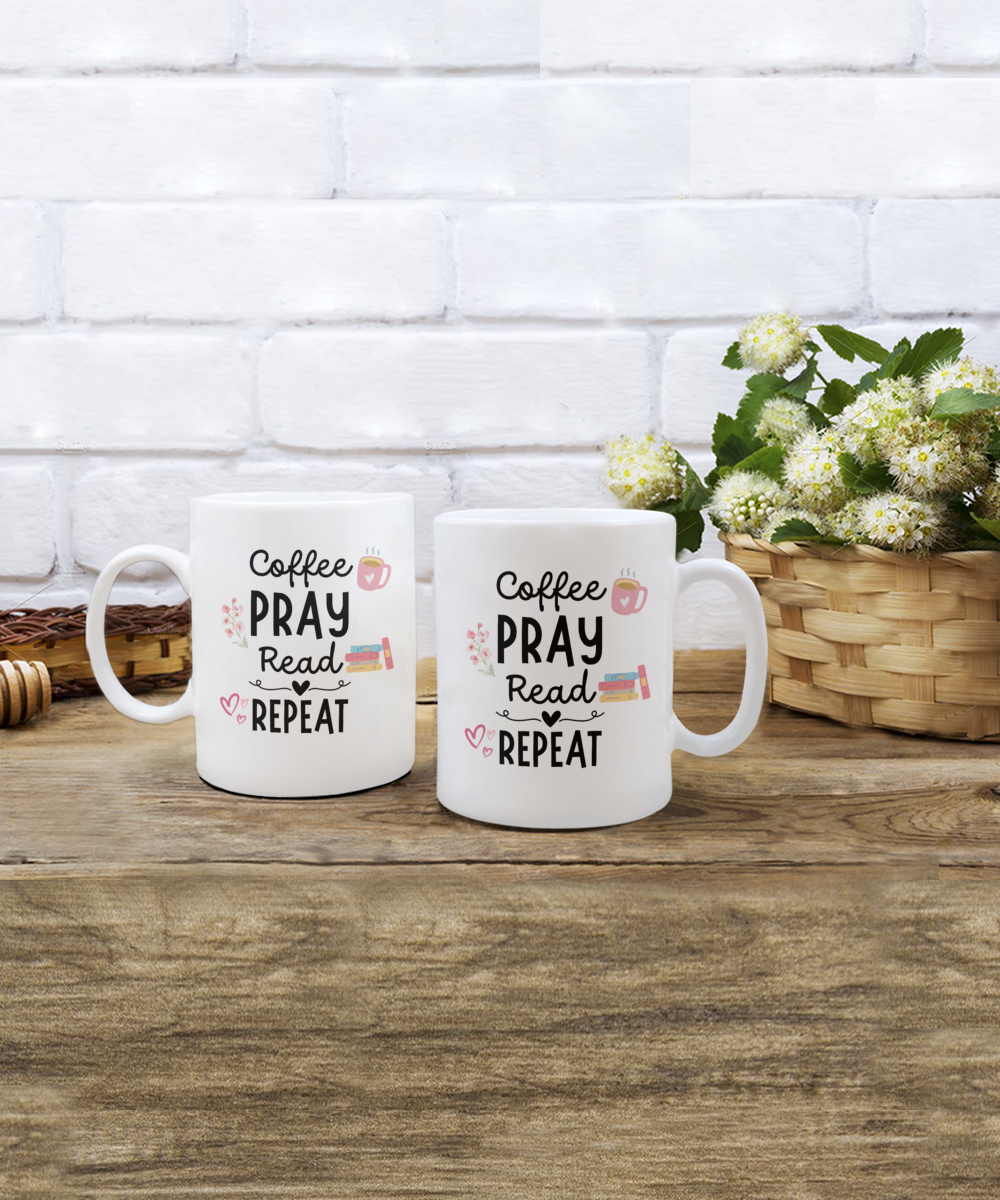 Two white "Coffee Pray Read Repeat" mugs sit on wood, with a basket of white flowers against a brick wall. Made and shipped in the USA, these exclusive mugs aren't in stores—get yours for a limited time! (Product: Coffee Pray Read Repeat Coffee Mug | Best Gift Ideas And Appreciation Cup For Reader).