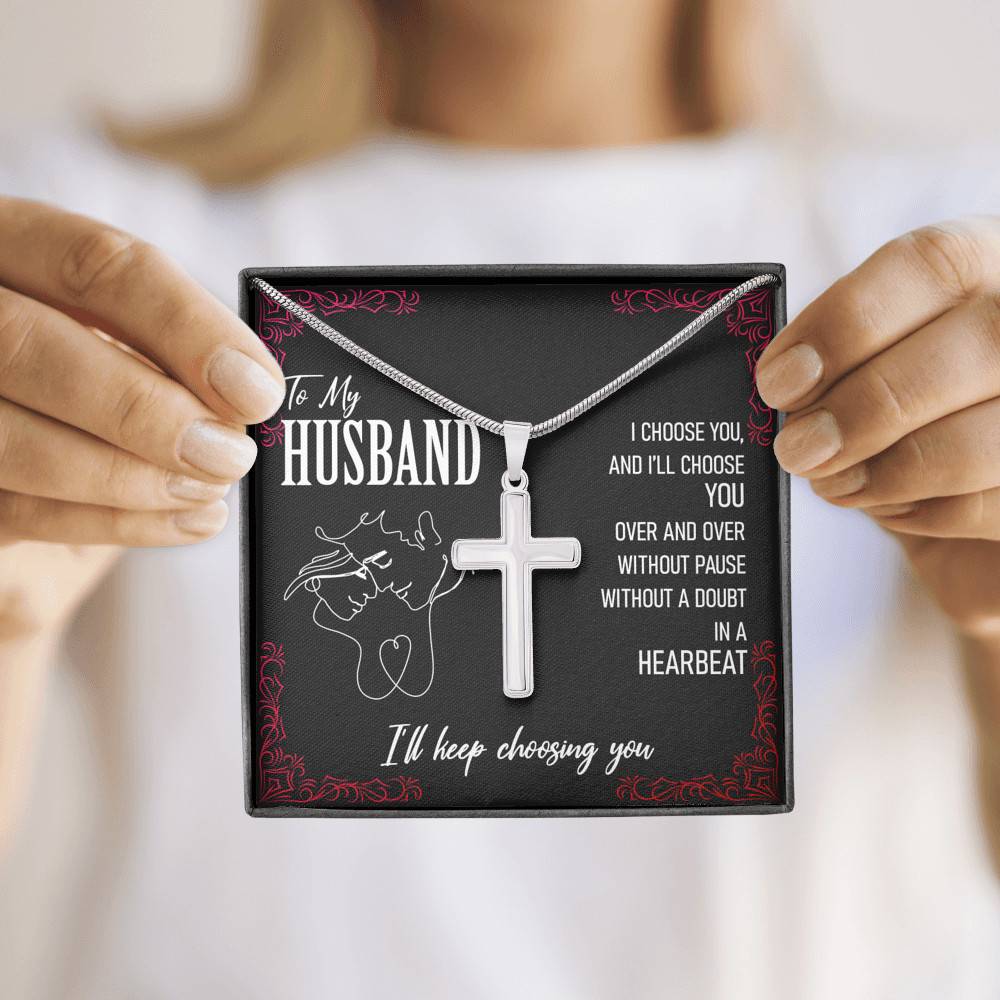 A woman holding up a necklace by slingly that says "To My Husband, I'll Keep Choosing You".