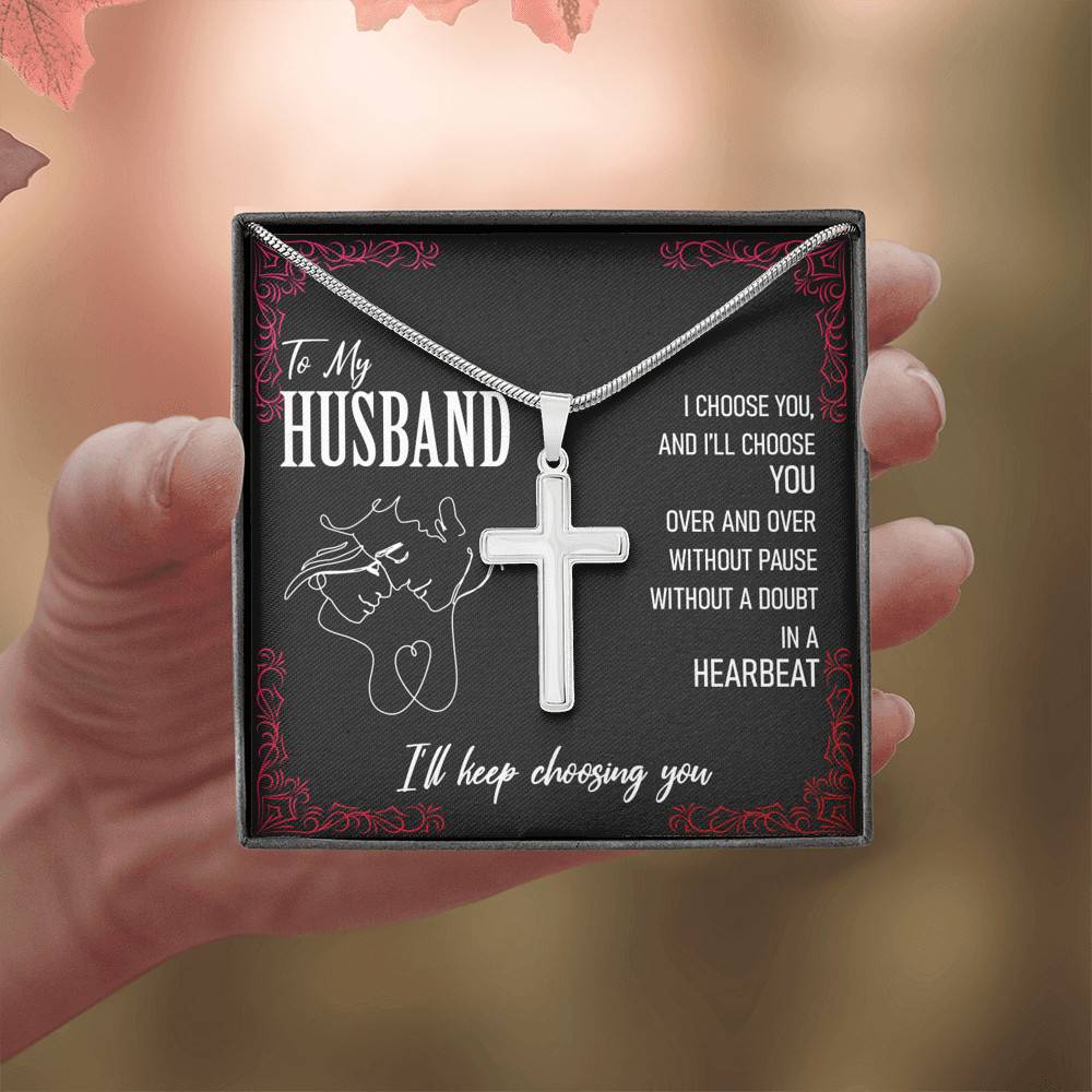 A slingly necklace with a cross on it that says "To My Husband, I'll Keep Choosing You".