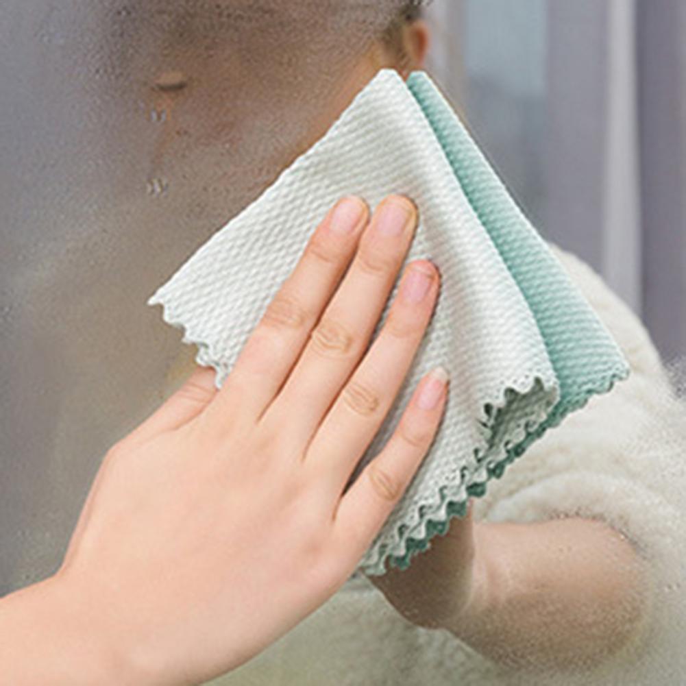 A person cleaning a window with a Fish Scale Nano Reusable Cleaning Cloth from MezoJaoie Wonder Lifestyle Store.