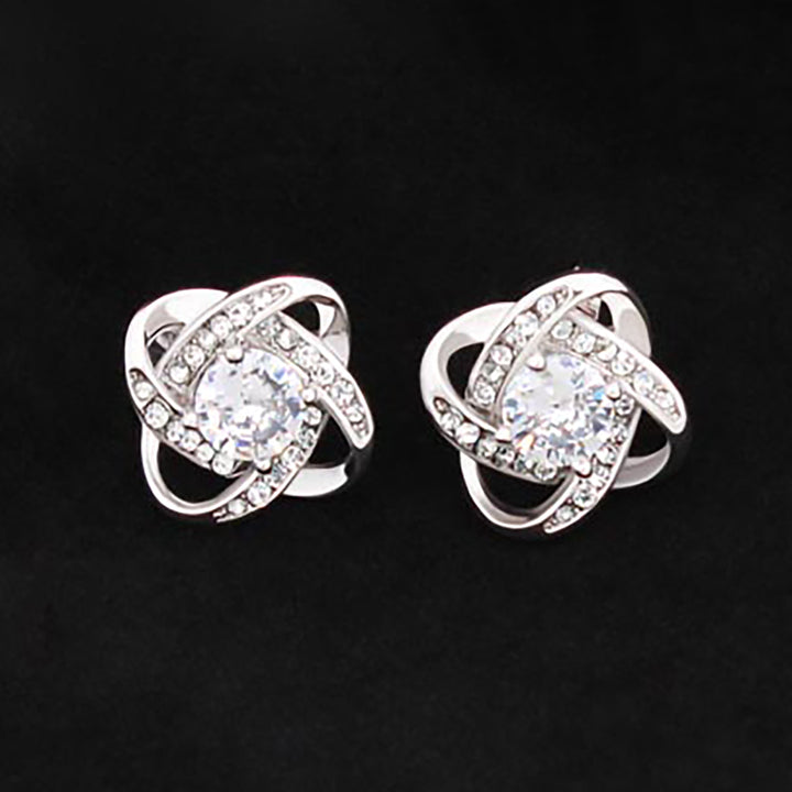 A pair of Love Knot Stud Earrings by ShineOn Fulfillment with diamonds.