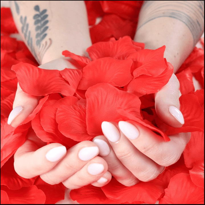 A woman holding a bunch of ShineOn Fulfillment red rose petals.