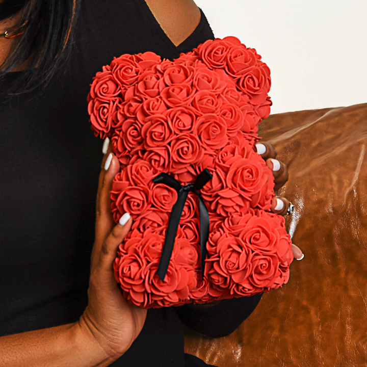 A woman holding a ShineOn Fulfillment Rose Bear.