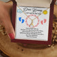 A hand holding a To New Mom - I Can't Wait to Meet You - Alluring Beauty Necklace with a poem on it by ShineOn Fulfillment.