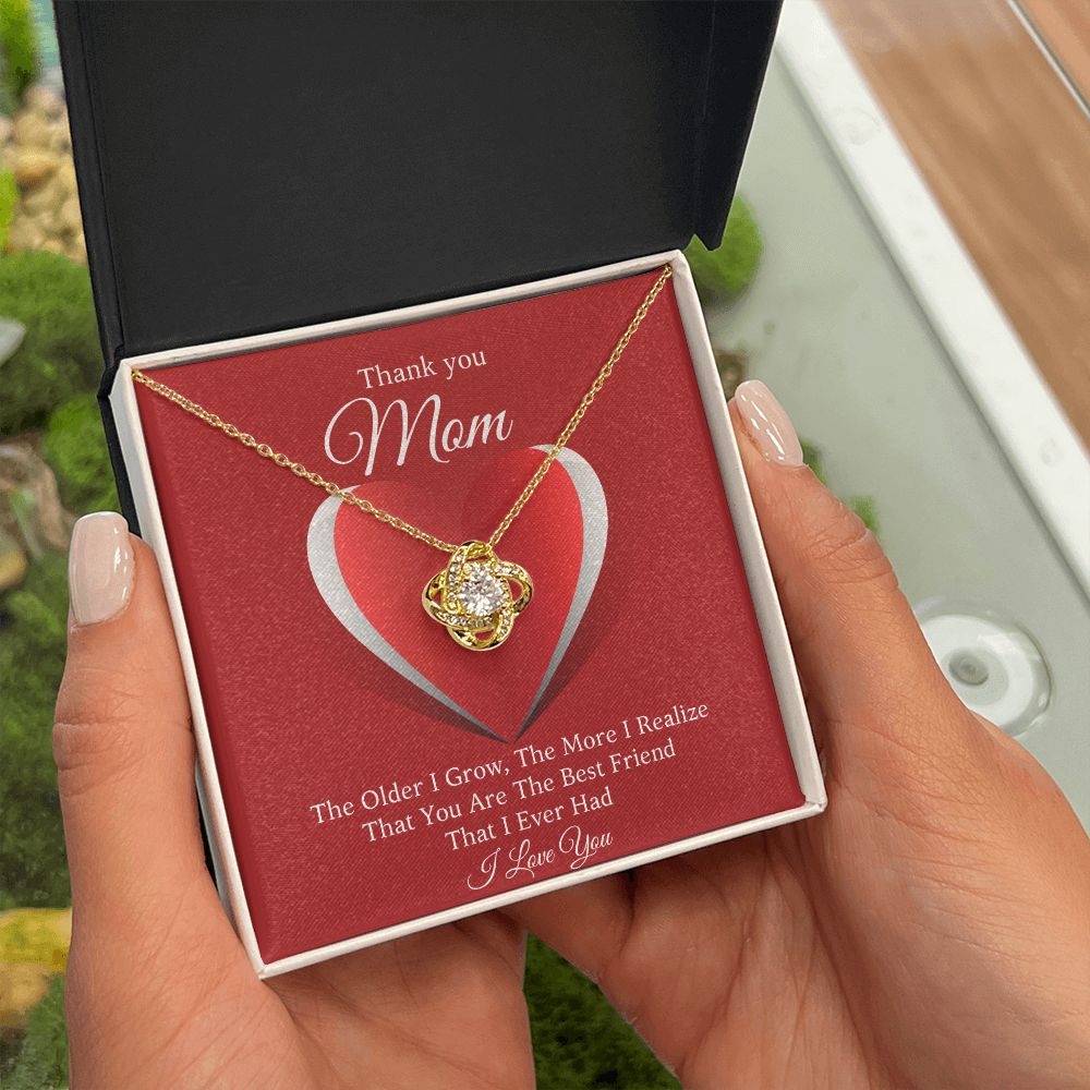 A person holding a gift box with a ShineOn Fulfillment You Are The Best Friend That I Ever Had Love Knot Necklace For Mom.