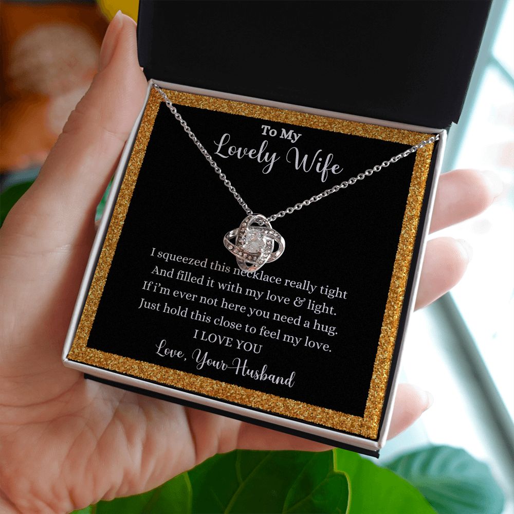 A woman holding a I Love You Love Knot Necklace - Gift for Wife from Husband with a quote on it by ShineOn Fulfillment.