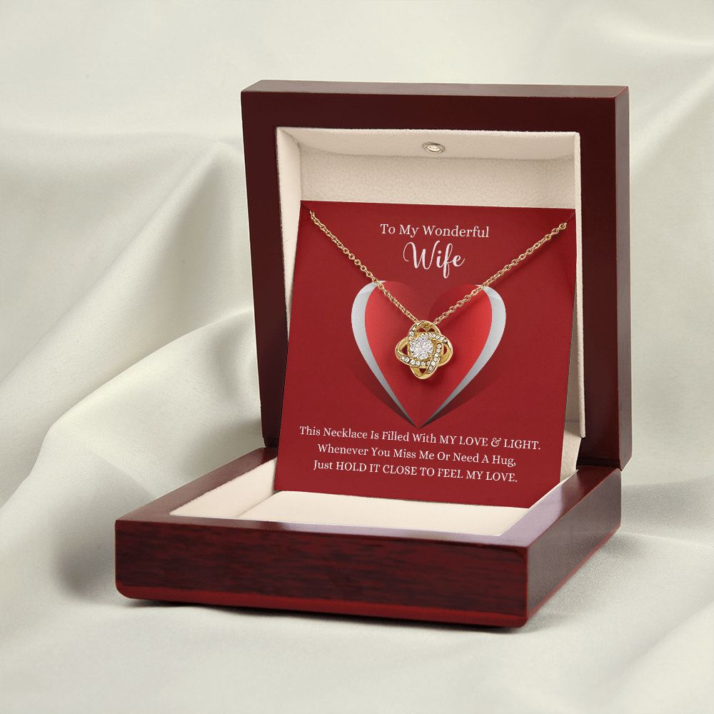A wooden box with the This Necklace Is Filled with My Love & Light Love Knot Necklace - For Wife by ShineOn Fulfillment in it.
