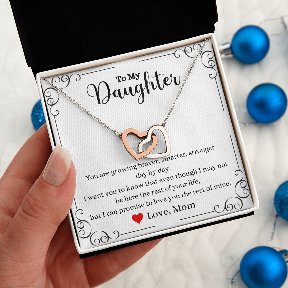 A woman holding a Love You The Rest of Mine Interlocking Hearts Necklace - Gift for Daughter from Mom by ShineOn Fulfillment.