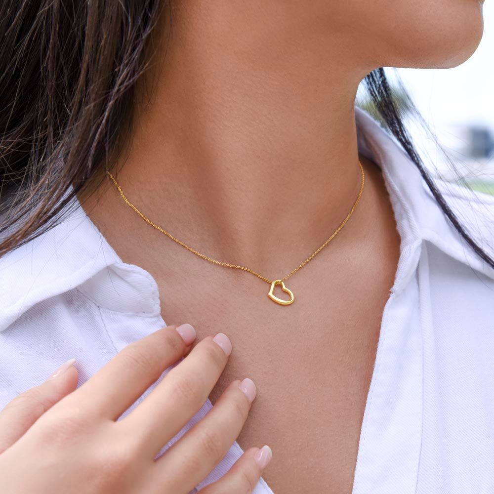 A woman wearing the "I'll Always Be By Your Side Delicate Heart Necklace - Gift for Daughter from Mom" by ShineOn Fulfillment.