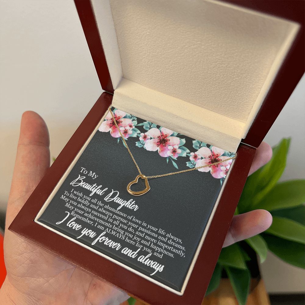 A person holding a gift box with the "I Wish You All The Abundance of Love - Delicate Heart Necklace For Daughter" by ShineOn Fulfillment in it.