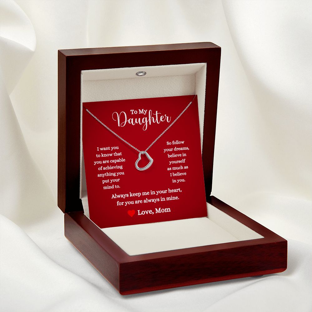A red box with a You Are Capable of Achieving Anything Delicate Heart Necklace - For Daughter From Mom by ShineOn Fulfillment in it.