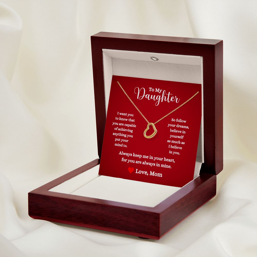 A gift box with the "You Are Capable of Achieving Anything Delicate Heart Necklace - For Daughter From Mom" necklace and a poem on it, brand by ShineOn Fulfillment.