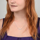 A woman with red hair wearing a ShineOn Fulfillment Personalized Custom Name Necklace with No Message Card.